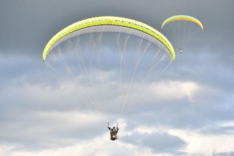Paragliding over the green hills of Bir Billing, Himachal Pradesh